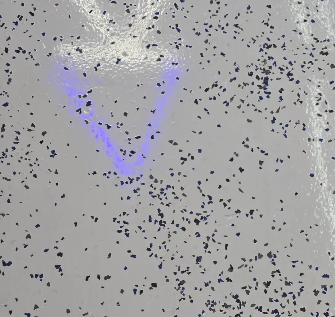 Close-up of decorative flakes set into a grey epoxy floor
