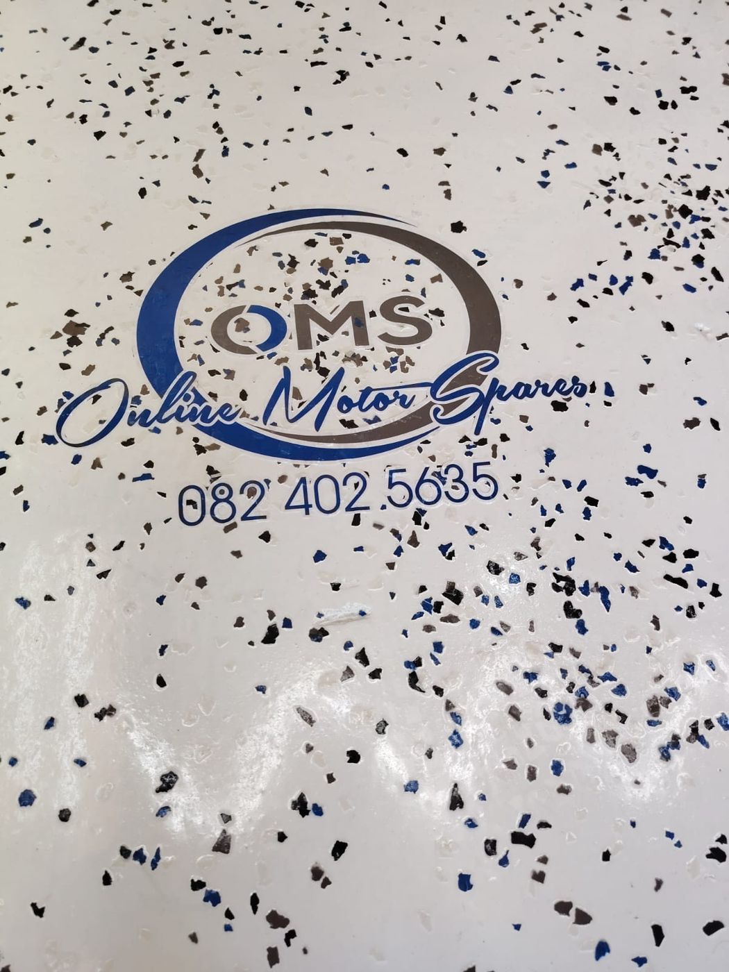 Epoxy flake floor with a customer company logo set into the coating