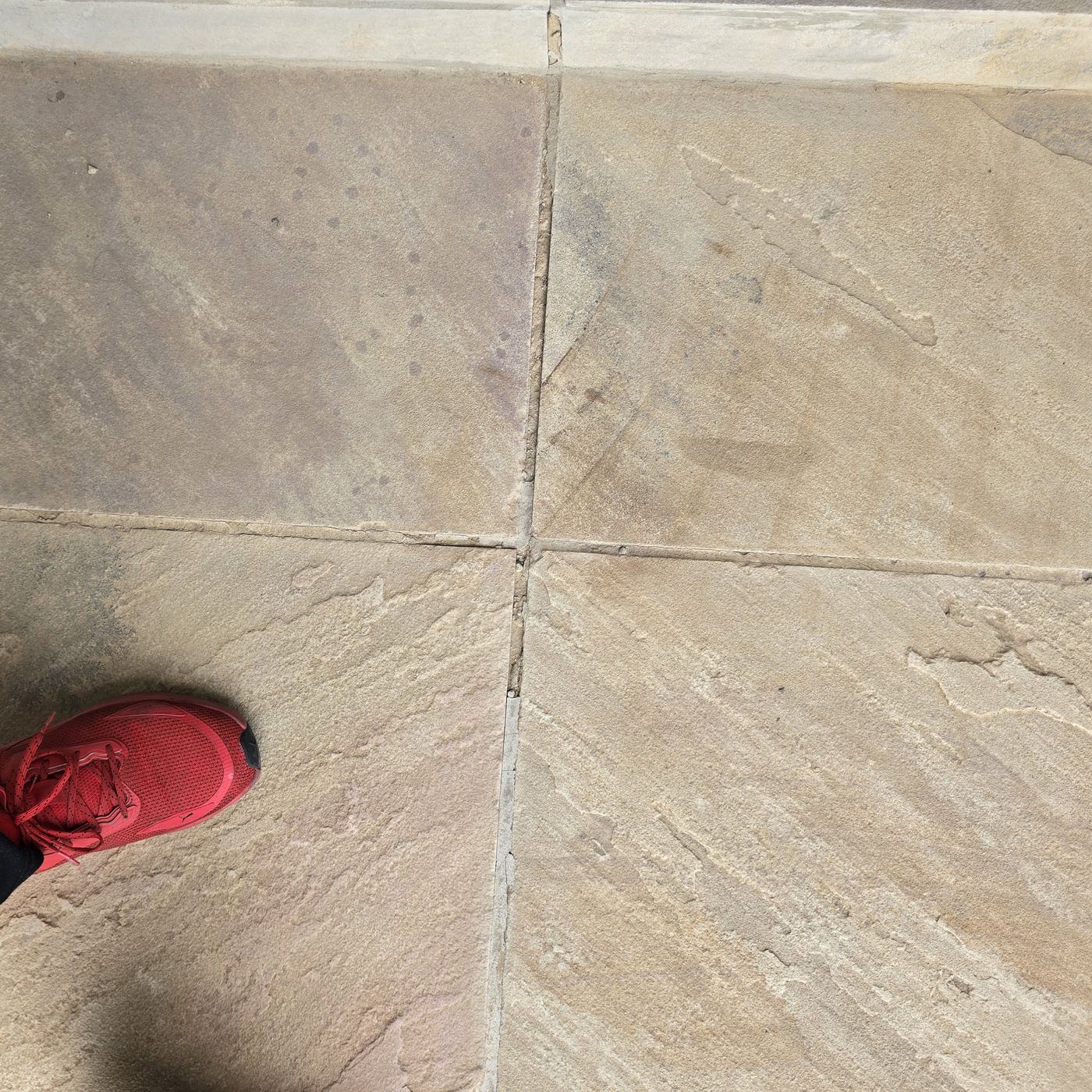 Uncoated sandstone paving slabs in a second section