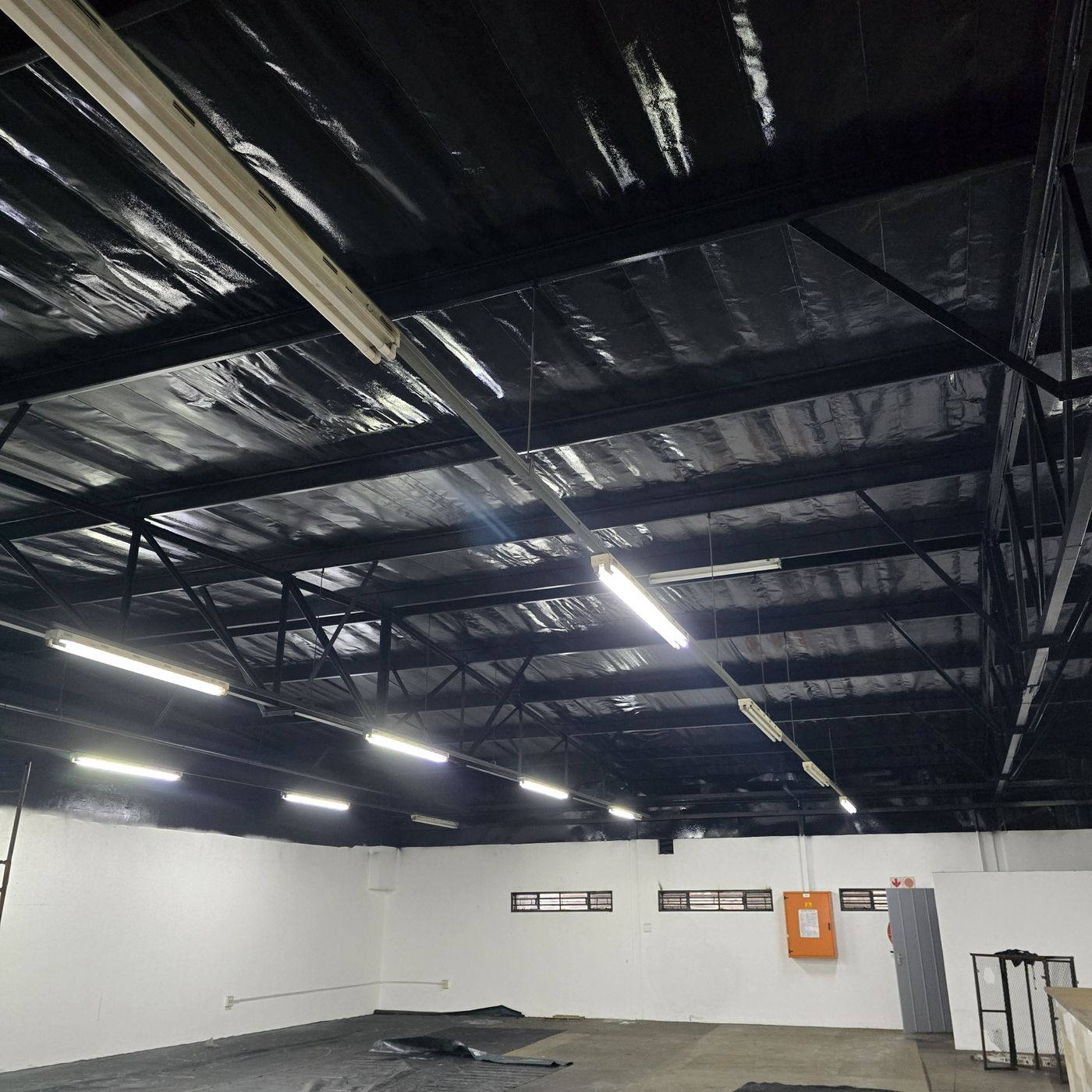 The same warehouse ceiling and beams repainted black